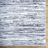 Close-up of the Azmina Area Rug, showcasing its contemporary black, ivory, and light blue horizontal stripe pattern. Swatch