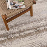 Close-up of the Asmara Brown Area Rug showcasing its textured, contemporary stripe design in ash, pearl, and brown tones. Styleshot