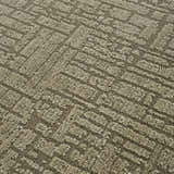 Close-up of the Leanna Green Washable Area Rug. The rug has a textured, geometric pattern in shades of gray and green. Texture
