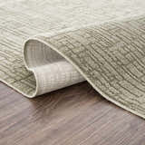 Close-up of the Leanna Green Washable Area Rug showing its gray-green color and textured, solid pattern. Fold