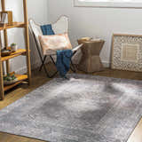 Living room scene with a Livabliss Colin rug in charcoal, cream, and red, under a chair and side table. Roomscene-Rectangle