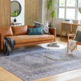 Living room scene with a Livabliss Colin rug in charcoal, cream, and red under a coffee table and leather sofa. Roomscene-Rectangle