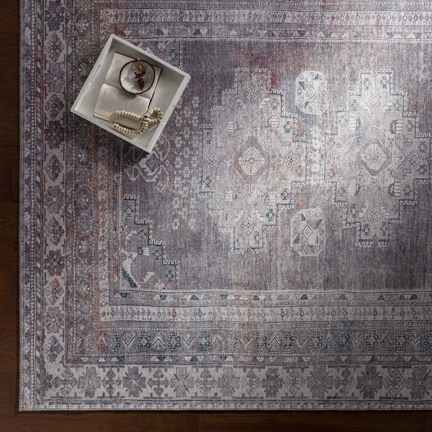 Close-up of the Livabliss Colin rug, a machine-woven rug in charcoal, cream, and red with a traditional pattern. Styleshot