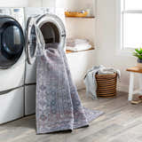 Laundry room with Livabliss Colin rug in a washing machine, showcasing its washable feature. Farmhouse style with gray wood floors. Washing-Machine