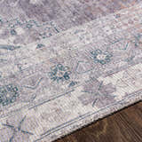 Close-up of the Livabliss Colin rug, a machine woven rug with a traditional charcoal, cream, and gray pattern. Texture