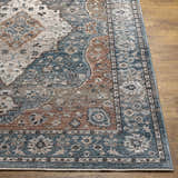 Close-up of the Edremit Area Rug. Traditional oriental pattern in cream, dark blue, dusty pink, and brown on wood floor. Front