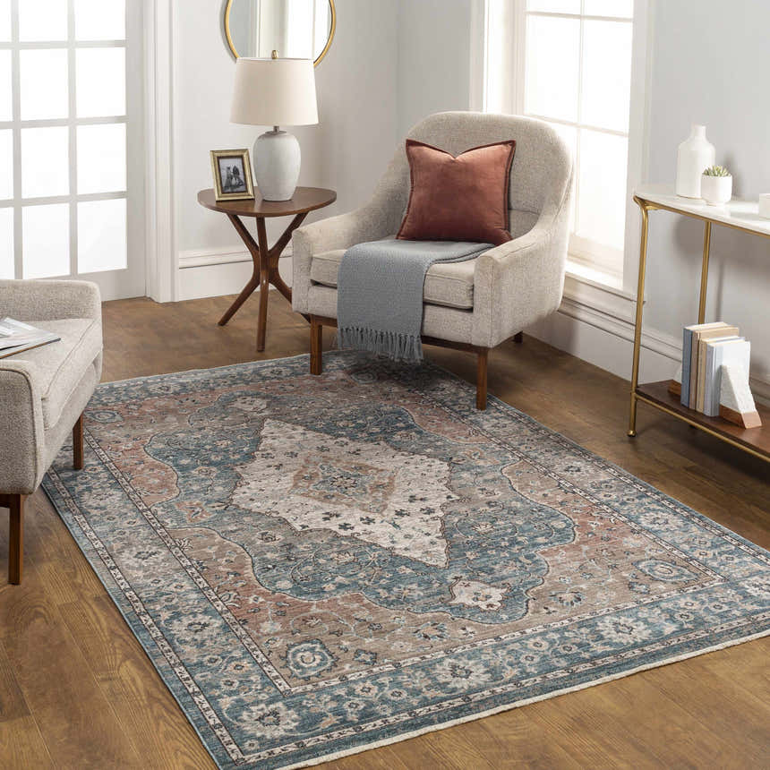 Living room scene with the Edremit Area Rug in cream, blue, and brown tones, styled with neutral furniture and wood floors. Roomscene-Rectangle