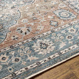 Close-up of the Edremit Area Rug showing the traditional oriental pattern in cream, blue, and brown tones. Texture