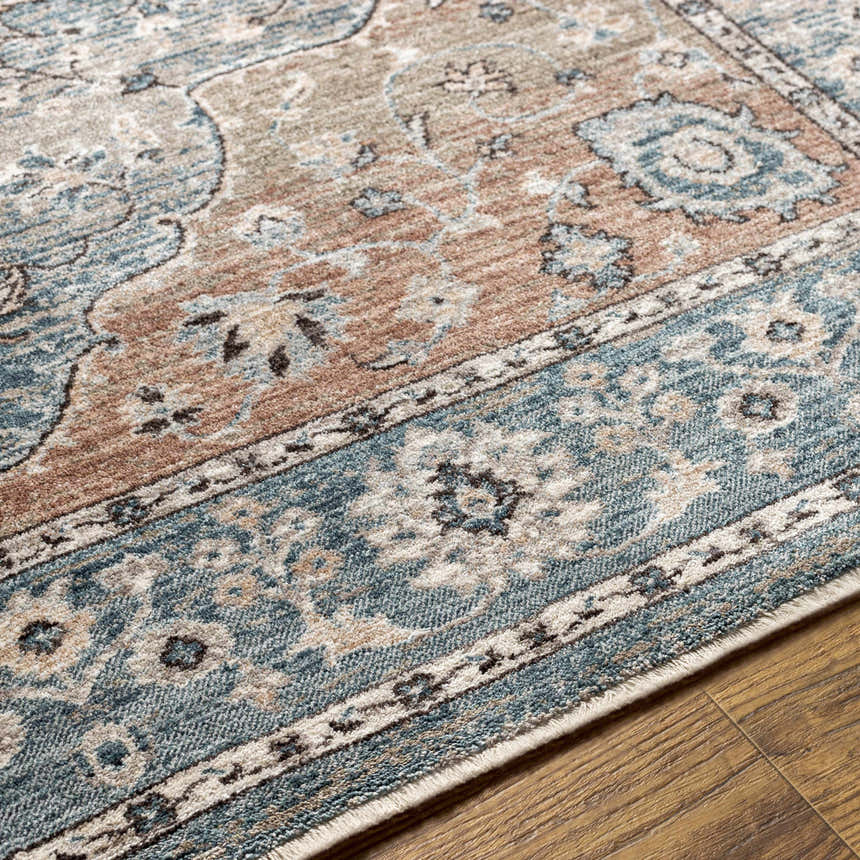 Close-up of the Edremit Area Rug showing the traditional oriental pattern in cream, blue, and brown tones. Texture