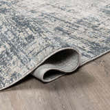 Close up of the Eltham Thick Luxe Rug in light gray and navy showing texture and construction. Fold