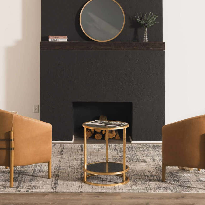 Living room scene with leather chairs and a gold accent table on the Eltham Thick Luxe Rug in dusty sage and light gray. Roomscene-Rectangle