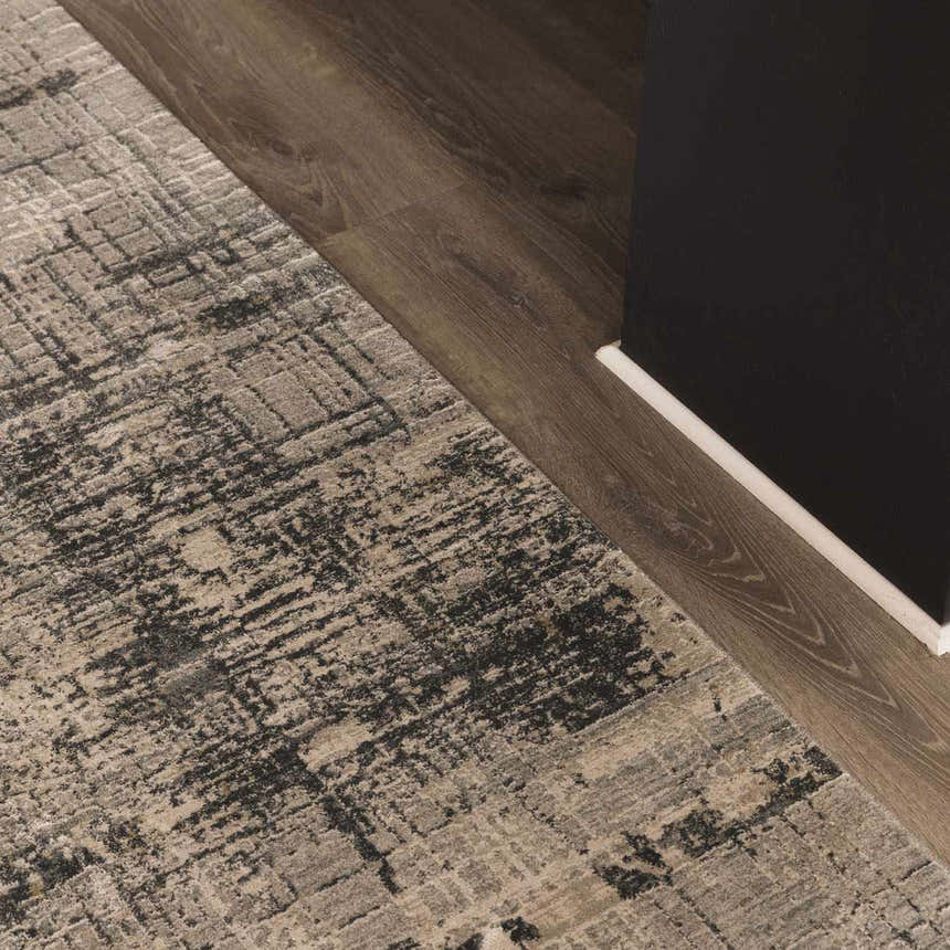 Close-up of the Eltham Thick Luxe Rug in taupe and black, showing its contemporary distressed pattern and soft texture. Roomscene-Rectangle
