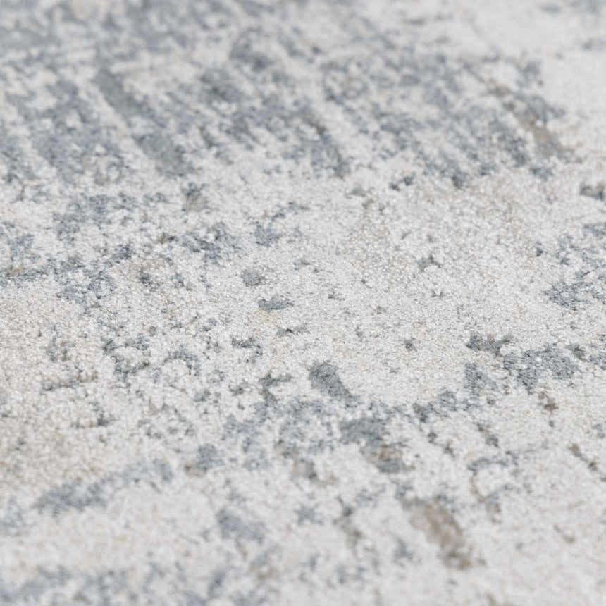 Close-up of the Eltham Thick Luxe Rug showing its plush texture and abstract pattern in light gray and white. Texture