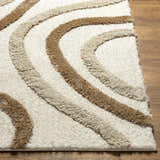 Close-up of the Espiye Area Rug showing the driftwood and dark brown wavy stripes and soft, shag texture. Front