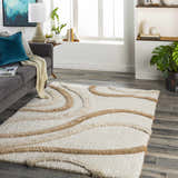 Living room scene with a gray sofa and the Espiye Area Rug, a shag rug with driftwood-colored wavy stripes. Roomscene-Rectangle
