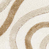 Close-up of Espiye Area Rug. Shag rug with dark brown, driftwood, and faded driftwood striped pattern. Soft texture. Texture