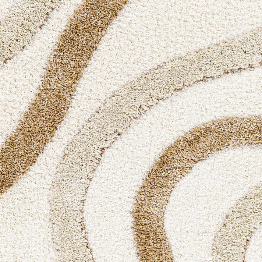 Close-up of Espiye Area Rug. Shag rug with dark brown, driftwood, and faded driftwood striped pattern. Soft texture. Texture