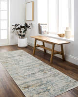 Entryway with wood floors and Aletta Washable Rug runner in beige, blue, and off white. Bench, plant, and natural light. Roomscene-Runner