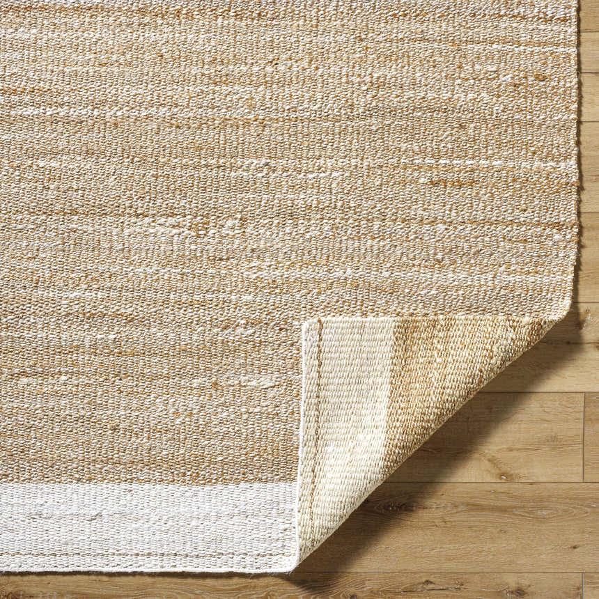 Close-up of hand-woven Aderyn Jute Area Rug showing camel, pearl, and tan colors and textured detail. Fold