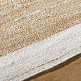 Close-up of the hand-woven Aderyn Jute Area Rug. Features camel, pearl, and tan jute fibers. Farmhouse style. Texture