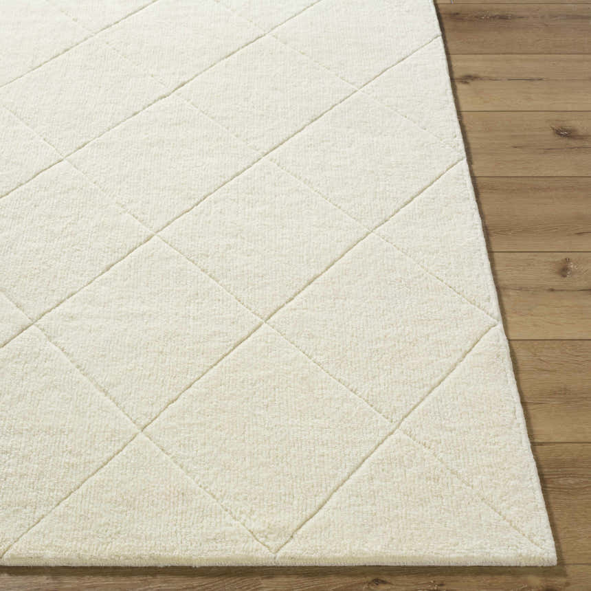 Close-up of the off-white Almeda Washable Wool Area Rug showing its hand-tufted texture and diamond pattern. Front