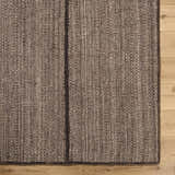 Close up of the hand woven Lisua Global wool rug showing texture and detail. Corner