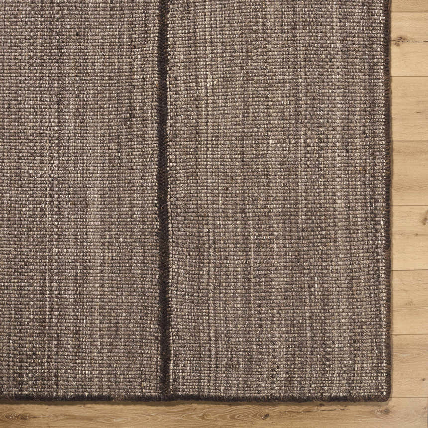 Close up of the hand woven Lisua Global wool rug showing texture and detail. Corner
