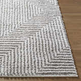 Close up of the Ashlyn Light Slate Area Rug showing its gray and white shag texture and geometric pattern. Front