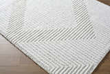 Close-up of the Ashlyn Cream Area Rug, a shag rug with a raised geometric chevron pattern. Corner