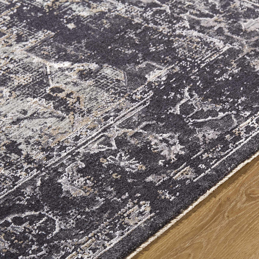 Close-up of the Alissa Black Area Rug showing its charcoal, gray, and ivory traditional pattern and soft texture. Texture