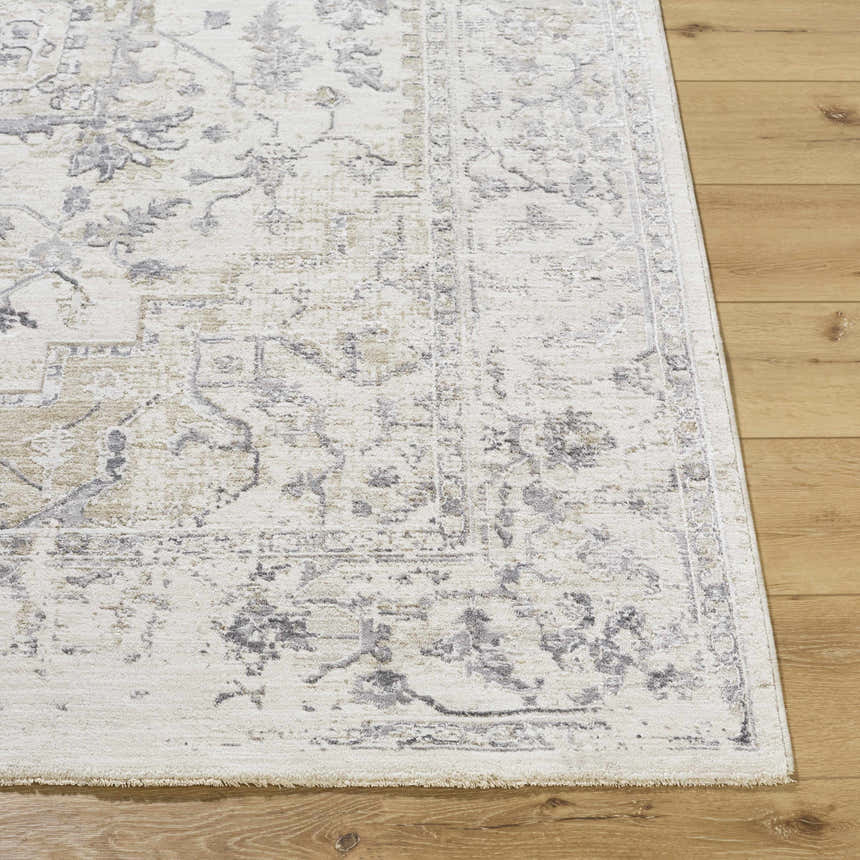 Close-up of the Alissa Cream Area Rug showing its traditional charcoal, gray, and tan floral pattern and soft texture. Front