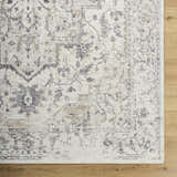 Close-up of Alissa Cream Area Rug showing farmhouse style, traditional charcoal, gray, and tan floral pattern on cream background. Corner