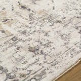 Close-up of the Alissa Cream Area Rug showing its charcoal, cream, and gray traditional pattern and soft texture. Texture