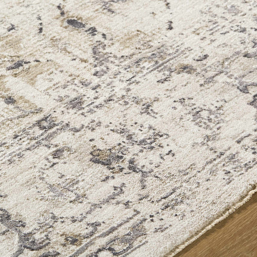 Close-up of the Alissa Cream Area Rug showing its charcoal, cream, and gray traditional pattern and soft texture. Texture