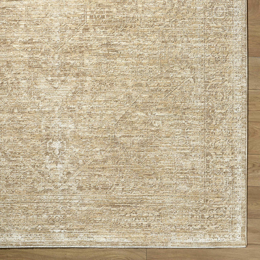 Close-up of the Antoan Sandstone Area Rug, a machine-woven rug in ivory, sandstone, and taupe with a traditional pattern. Corner