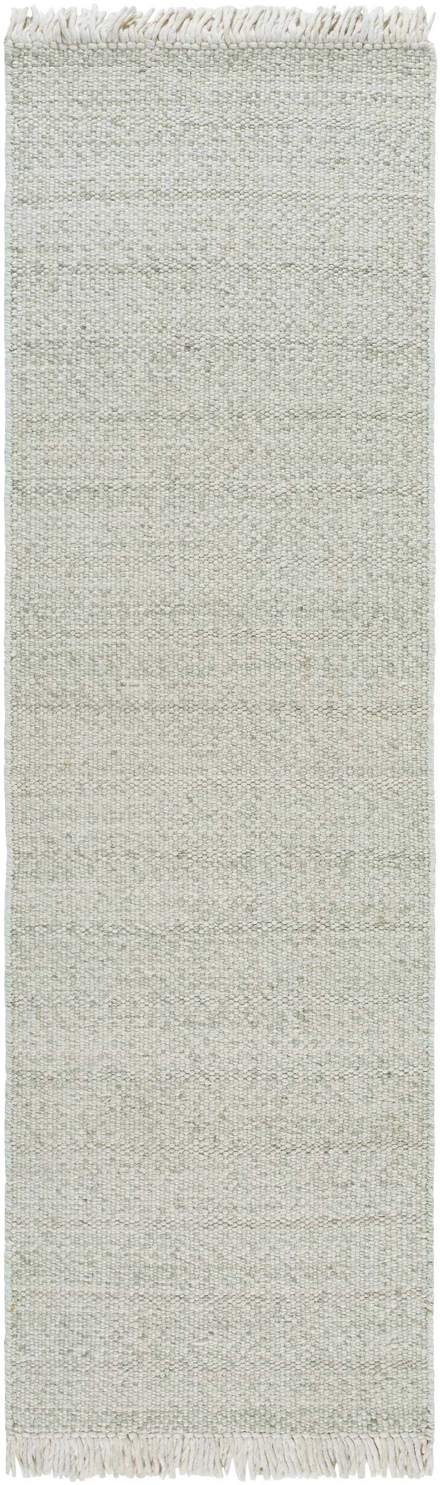 Close-up of the Sorell Sage Rug, a hand-woven wool rug with a textured ecru and sage weave and fringed edges. Design-Runner-268