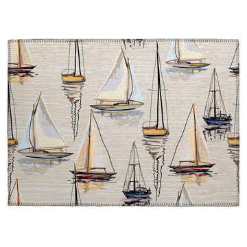 Dalyn Harbor HA8 Ivory Washable Area Rug with a beige backdrop and a pattern of sailboats in black, gold, and spice colors.