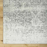 Close-up of the Livabliss Harput HAP-1024 area rug. Charcoal and off-white traditional pattern on a soft polypropylene texture. Corner