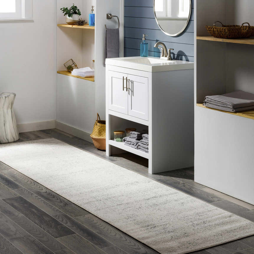 Bathroom scene with a Livabliss Harput HAP-1024 runner rug in charcoal, gray, and off-white on dark wood-look tile flooring. Roomscene-Runner
