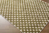 Close-up of Anthea Olive Washable Area Rug. Olive and white geometric basketweave pattern. Machine woven texture. Corner