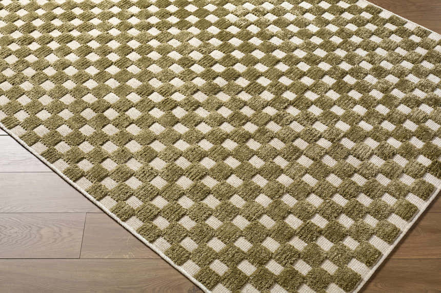 Close-up of Anthea Olive Washable Area Rug. Olive and white geometric basketweave pattern. Machine woven texture. Corner