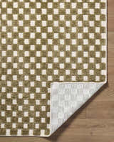 Close-up of the Anthea Olive Washable Area Rug, featuring a contemporary olive and white checkered pattern. Machine woven texture. Fold