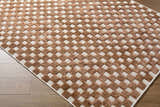 Close-up of the Anthea White Washable Area Rug. Brown textured squares on a white background create a contemporary geometric pattern. Corner