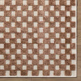 Close-up of the Anthea White Washable Area Rug, featuring a brown and white checkerboard pattern and textured weave. Corner