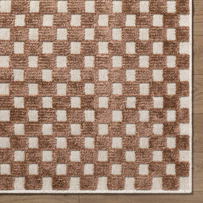 Close-up of the Anthea White Washable Area Rug, featuring a brown and white checkerboard pattern and textured weave. Corner
