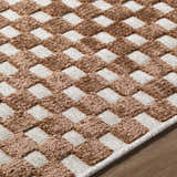 Close-up of the Anthea White Washable Area Rug. Brown and white checkerboard pattern with a soft, textured feel. Texture