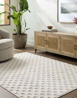 Living room scene with a light gray Anthea Washable Area Rug, beige swivel chair, and wood media cabinet. Roomscene-Rectangle