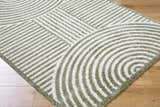 Close-up of Allard Green Washable Area Rug. Features a contemporary geometric pattern in lime green and white on a wood floor. Corner