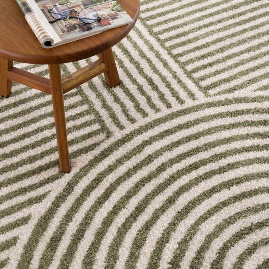 Close-up of the Allard Green Washable Area Rug featuring a geometric striped pattern in lime green and cream. Styleshot