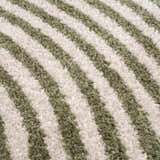 Close-up of the Allard Green Washable Area Rug, featuring a striped pattern in lime green and cream. Soft, textured polyester. Texture